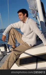 Man Sitting on Sailboat Deck