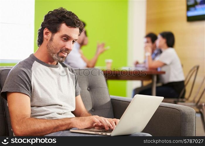 Man Sitting On Sofa And Working In Design Studio