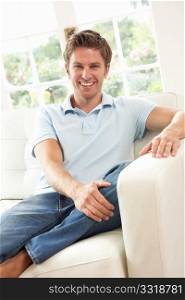 Man Sitting On Sofa Relaxing At Home