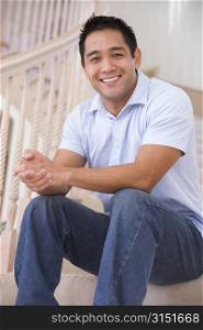 Man sitting on staircase smiling