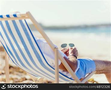 Man sitting on the beach . Relaxing at sea