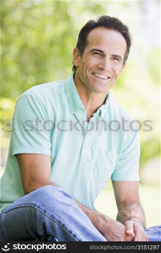 Man sitting outdoors smiling