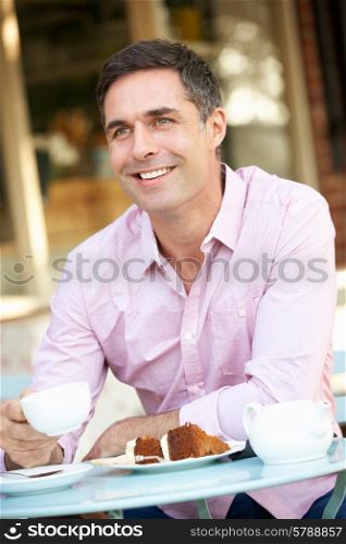 Man sitting outside cafe