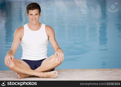 Man sitting poolside smiling