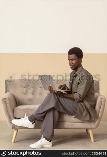 man sitting sofa works