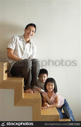 Man Sitting with Children on Stairs