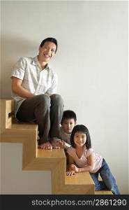Man Sitting with Children on Stairs