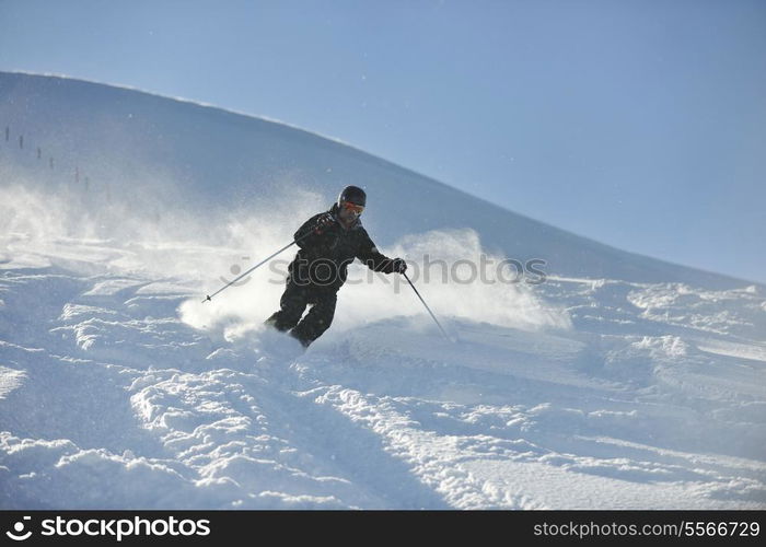 man ski free ride downhill at winter season on beautiful sunny day