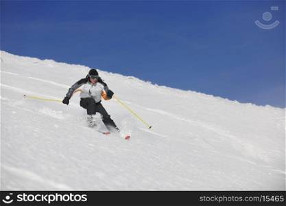 man ski free ride downhill at winter season on beautiful sunny day and powder snow