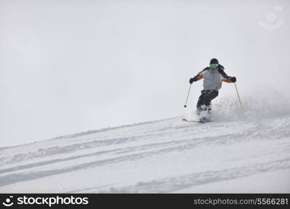 man ski free ride downhill at winter season on beautiful sunny day and powder snow