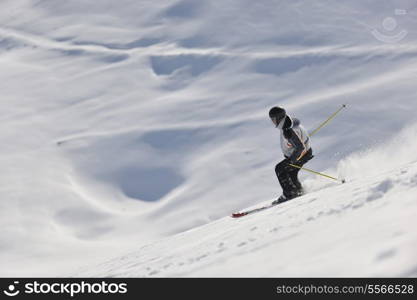 man ski free ride downhill at winter season on beautiful sunny day and powder snow