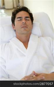 Man sleeping in bathrobe, outdoors