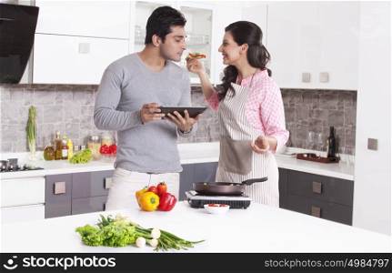 Man smelling his wifes cooking