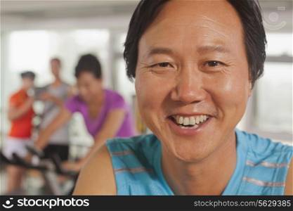 Man smiling and exercising on the exercise bike