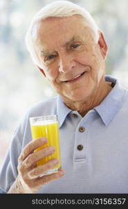 Man Smiling At Camera And Drinking Orange Juice