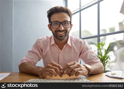 Man smiling in front of desktop