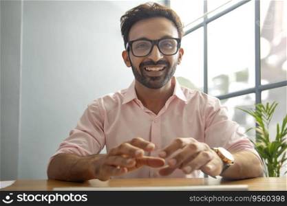 Man smiling in front of desktop
