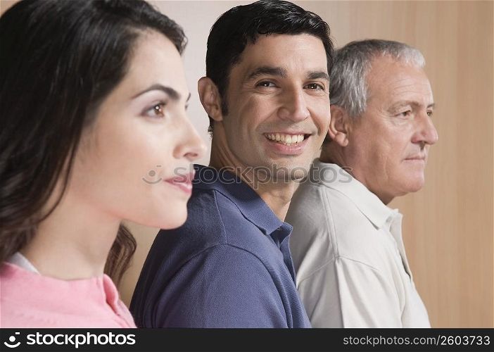 Man smiling with his family beside him