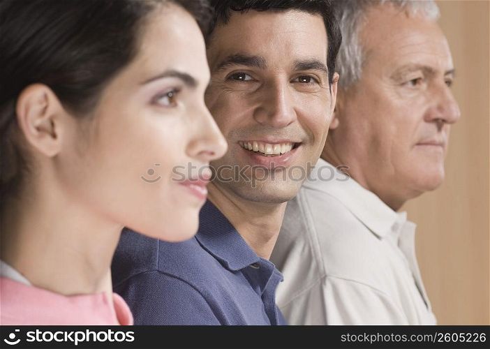 Man smiling with his family beside him