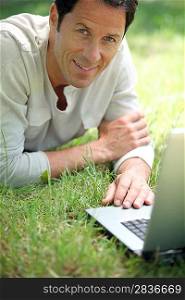 Man smiling working on the grass