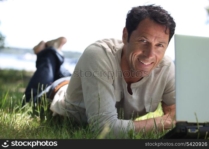 Man smiling working on the grass