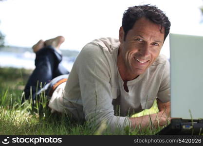Man smiling working on the grass
