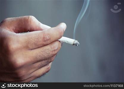 man smoking a cigarette. Cigarette smoke spread.