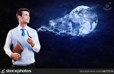 Man smoking pipe. Conceptual image of young handsome man smoking pipe