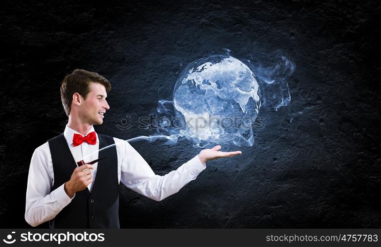 Man smoking pipe. Young handsome businessman in fumes smoking pipe