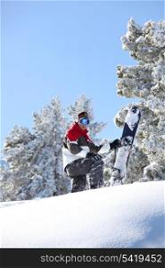 Man snowboarding down snowy hill