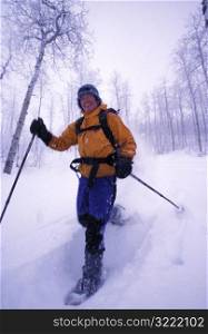 Man Snowshoeing and Laughing