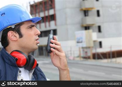 Man speaking into a walkie-talkie