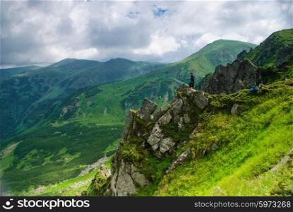 Man stand on the rocks in Carpathian mountains. Man in mountains