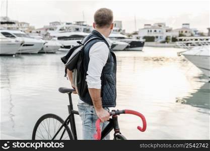 man standing his bike