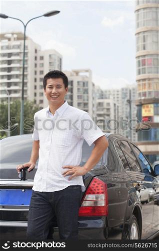 Man standing next to his car