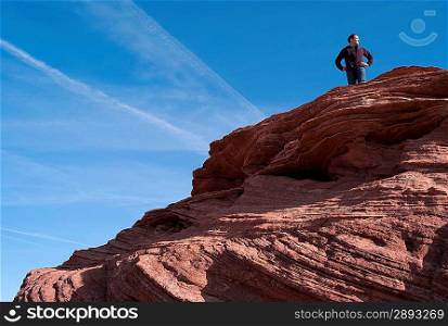 Man standing on a rock, Horseshoe Bend, Glen Canyon National Recreation Area, Arizona-Utah, USA