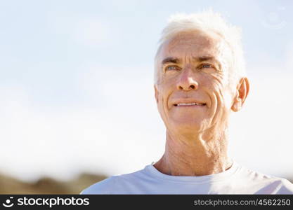 Man standing on beach in sports wear. Man standing on beach in sports wear looking fit and happy