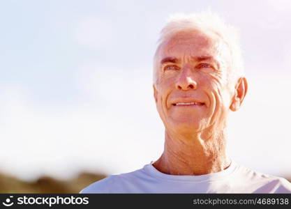 Man standing on beach in sports wear. Man standing on beach in sports wear looking fit and happy