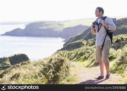 Man standing on cliffside path