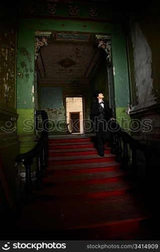 man standing on red ladder. indoor shot