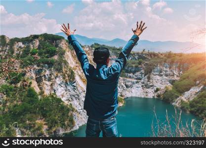 Man standing on rock mountain at lake view
