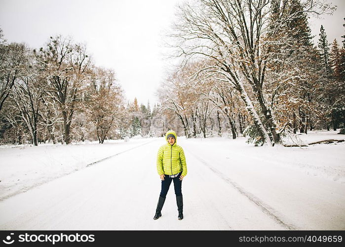 Man standing on snow-covered landscape looking at camera