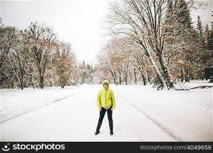 Man standing on snow-covered landscape looking at camera