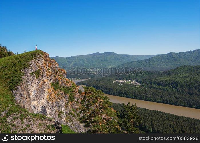 Man standing on top of cliff. Man standing on top of cliff in summer beauty day in Altai mountains
