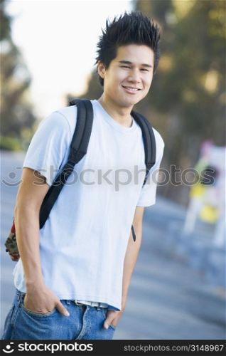 Man standing outdoors smiling (selective focus)