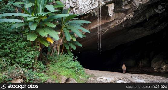 Man standing outside a cave, Thailand