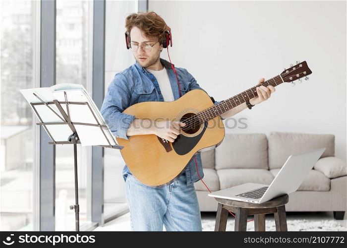 man standing trying learn musical instrument