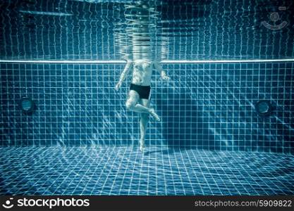 Man standing under water in a swimming pool