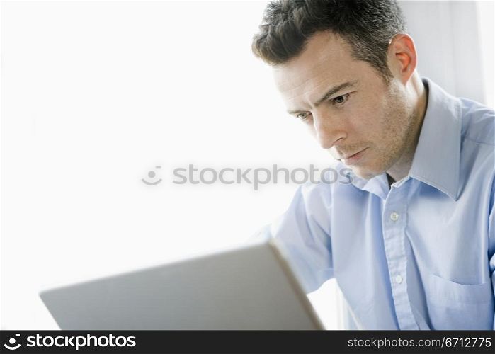 man staring at laptop screen