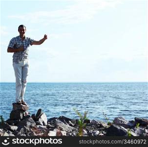 man stay on ground sea on background